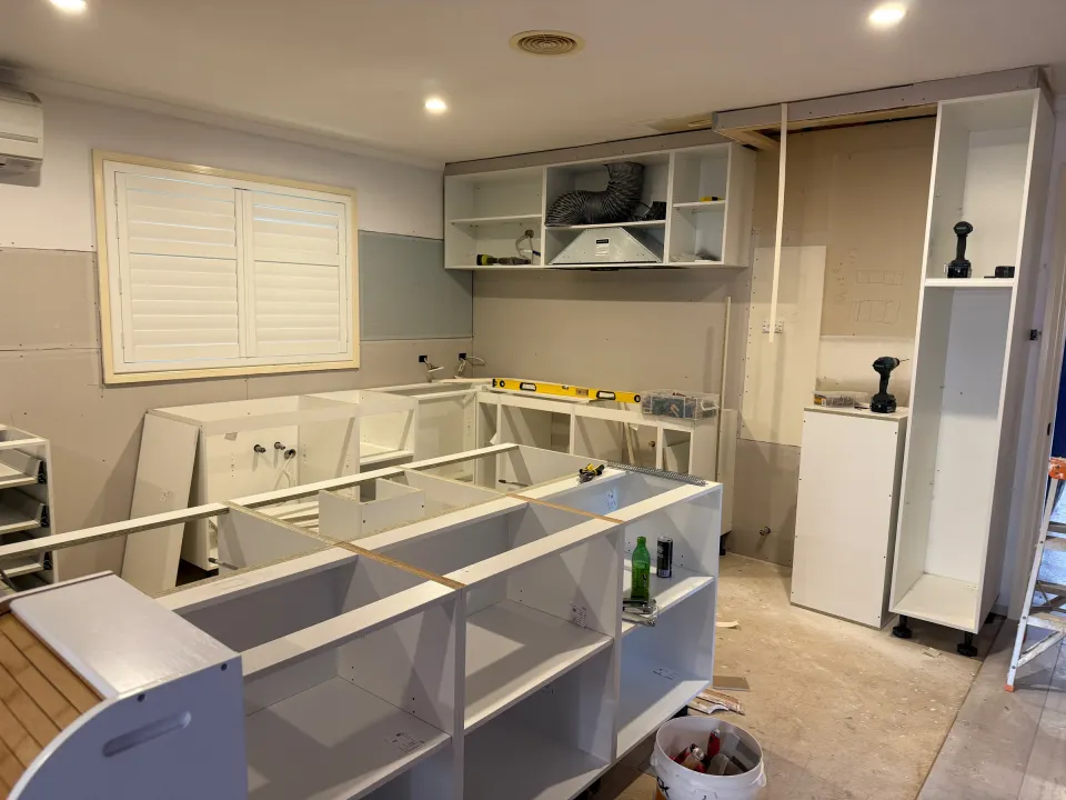Point Cook kitchen during installation, showing cabinet carcasses and the unfinished island