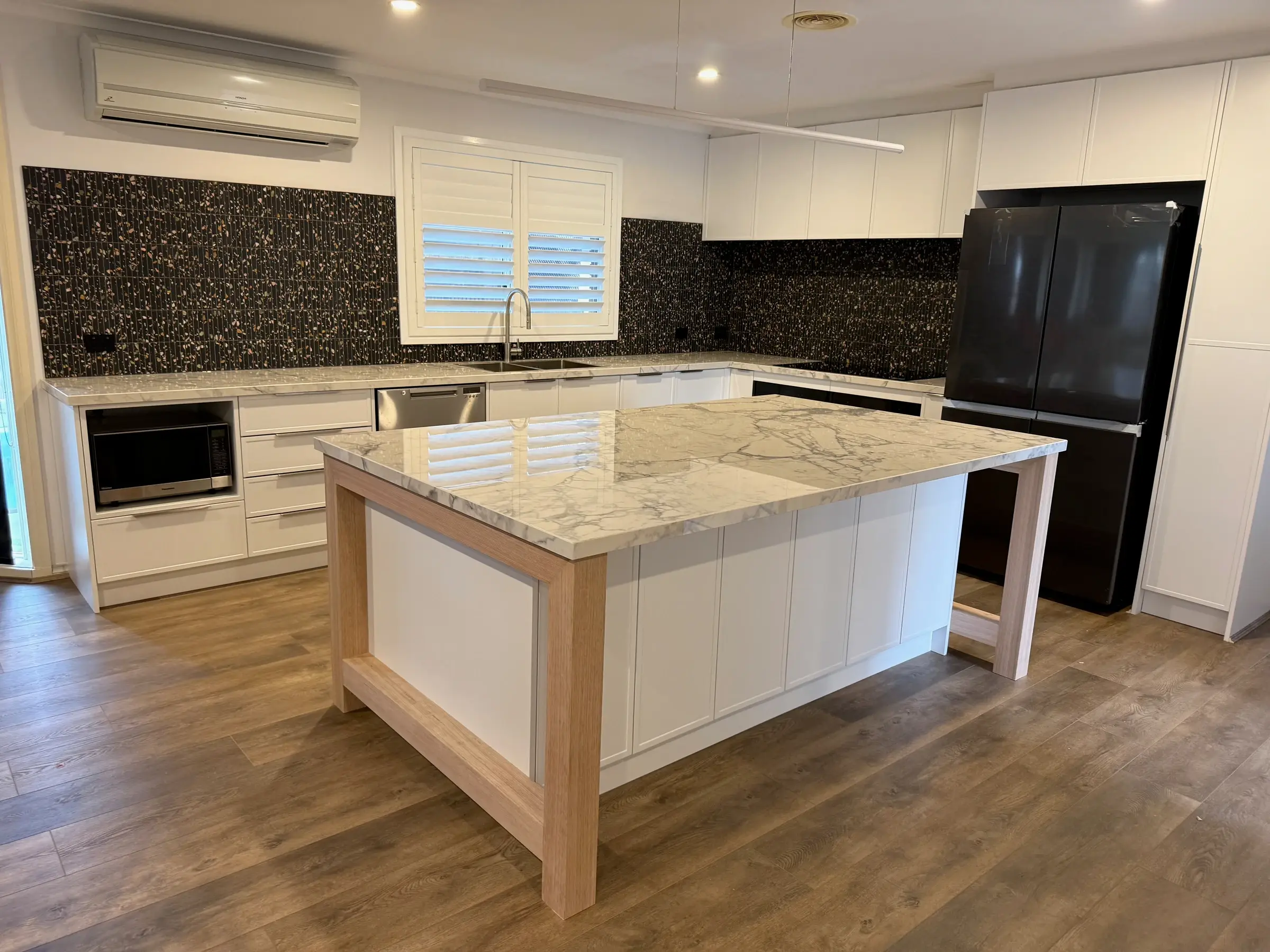 Completed Bluestone kitchen with an island and pendant lighting