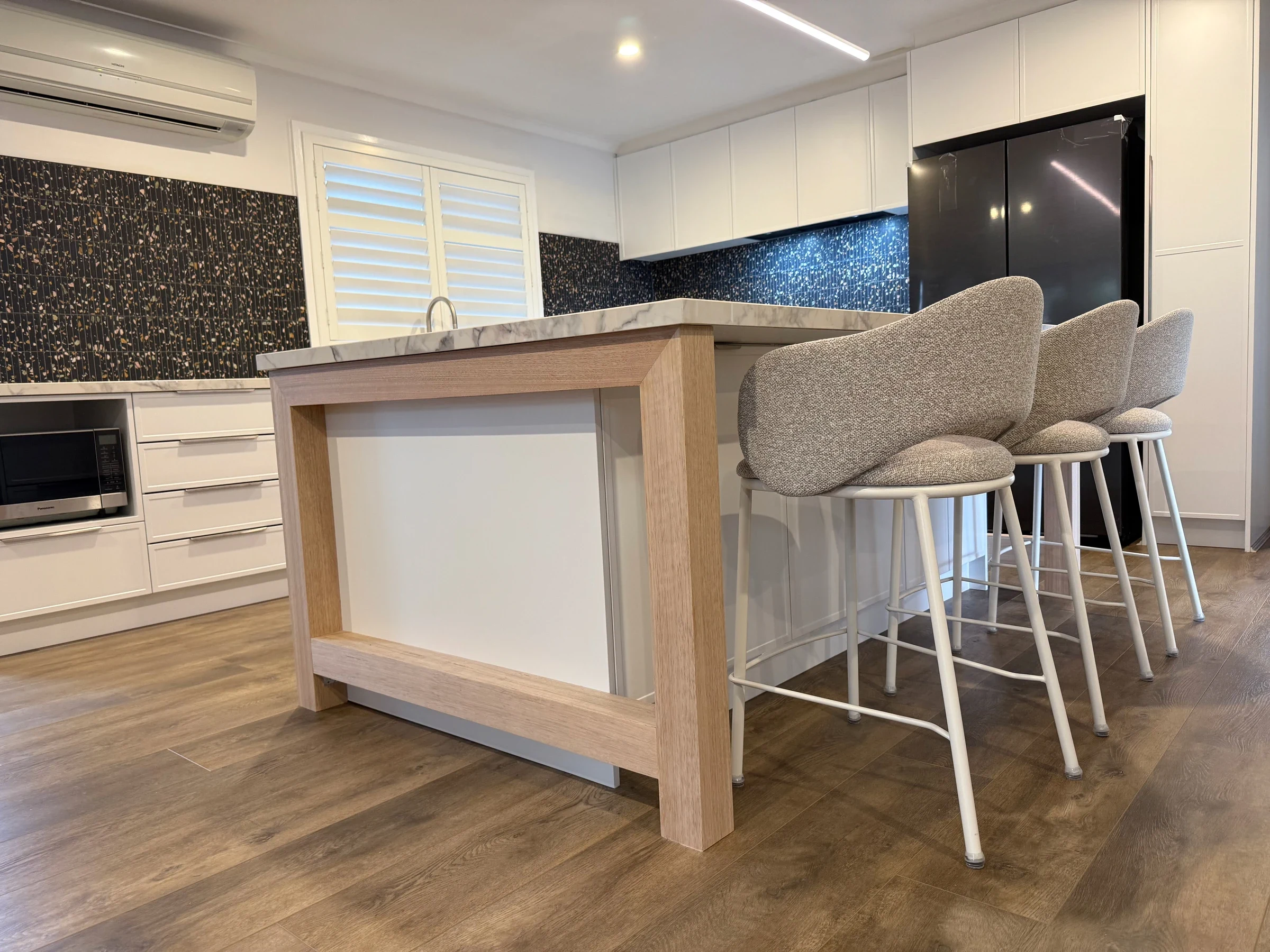 Three seats at the completed Point Cook kitchen island