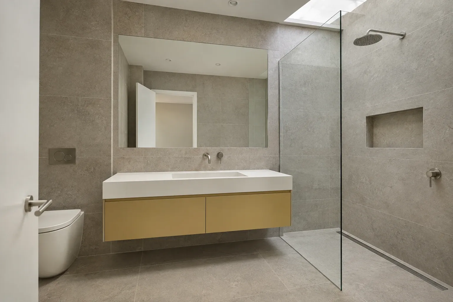 Ochre joinery and quiet stone — bathroom design inspiration