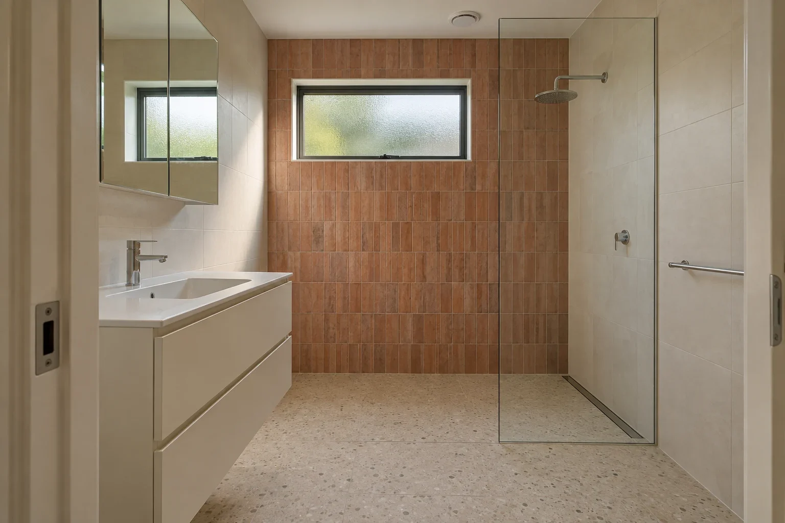 Terracotta tile with an ivory vanity — bathroom design inspiration