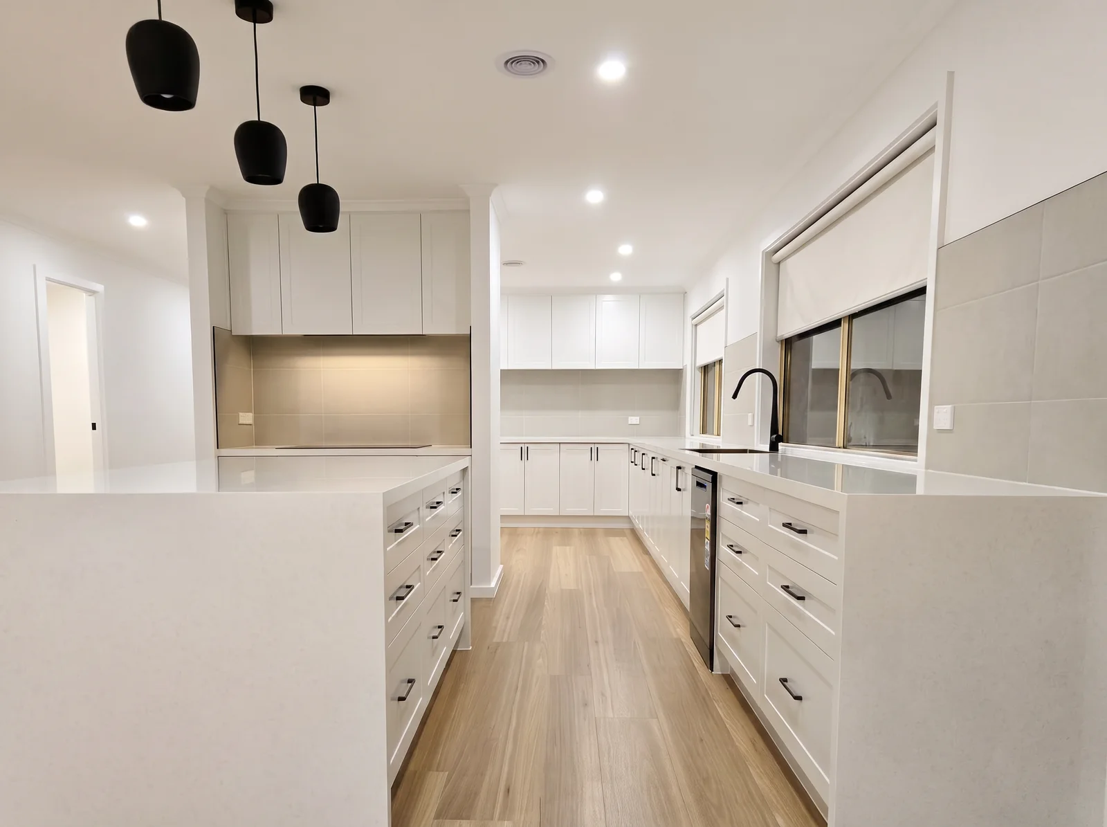 White galley kitchen with black fittings