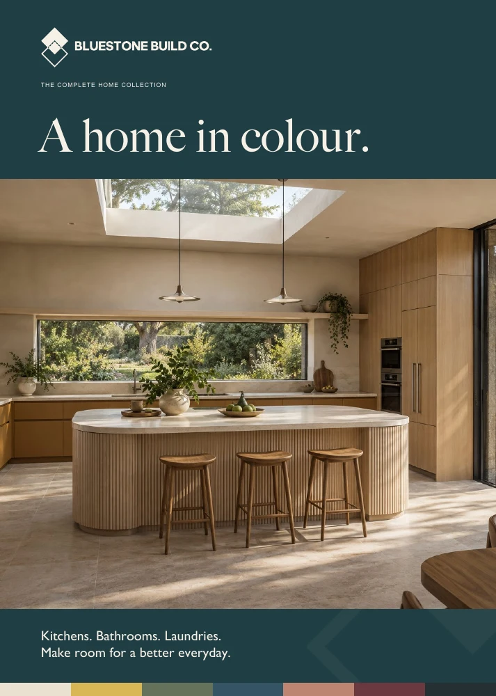 The collection cover: an ochre kitchen with a sculpted island and skylight